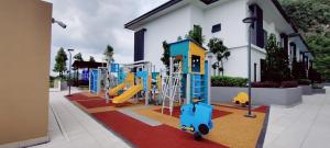 un parque infantil con un tobogán frente a un edificio en H&W Sunway Onsen Suites Services Tambun Ipoh S-07-05 en Ipoh