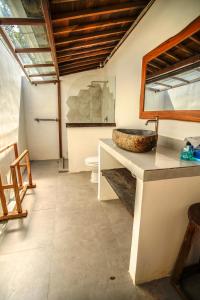 a bathroom with a sink and a toilet at Villa Miti Bingin in Uluwatu