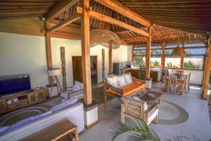 a living room with a couch and a tv at Villa Miti Bingin in Uluwatu