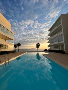 a swimming pool in front of a building at Cap Tingis in Tangier