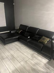 a black leather couch in a living room at Welcome to the AUC Modern Unit in Atlanta