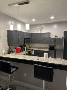 a kitchen with a counter and two bar stools at Welcome to the AUC Modern Unit in Atlanta