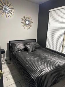 a bedroom with a bed and a clock on the wall at Welcome to the AUC Modern Unit in Atlanta