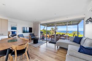 a living room with a couch and a table and chairs at Ingenia Holidays Cape Paterson in Cape Paterson