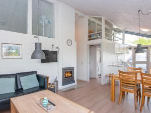 a living room with a couch and a table and a fireplace at 5 person holiday home in Aabenraa-By Traum in Aabenraa