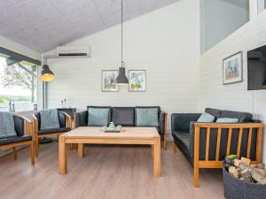 a living room with couches and a table at 5 person holiday home in Aabenraa-By Traum in Aabenraa