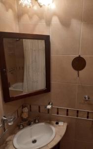 a bathroom with a sink and a mirror and a tub at imanalla in Salta