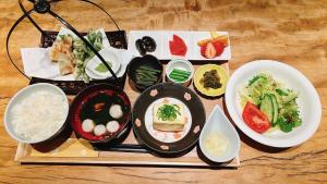 a group of bowls of food on a wooden table at irodori in Matsumoto