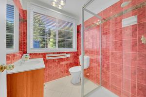 a bathroom with a toilet and a glass shower at 406 Back Porepunkah Road, Bright in Bright +9 photos
