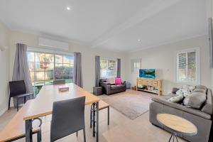 a living room with a couch and a table at 406 Back Porepunkah Road, Bright in Bright