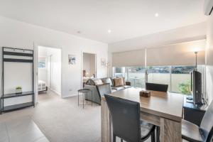 a dining room and living room with a table and chairs at Bellerive Quay - 2 Bedroom Apartment - Free Parking - Free WIFI in Bellerive