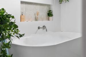 a white sink in a bathroom with a mirror at Dicky Beach Original - 2 Bed Downstairs Studio 200m to Beach in Caloundra