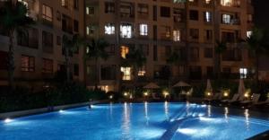 a large swimming pool in front of a building at night at Sarah Homestay - Masteri Thao Dien in Ho Chi Minh City