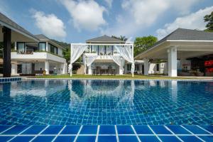 a view of a swimming pool in front of a house at Bluemango Pool Villa & Resort Koh Samui in Koh Samui