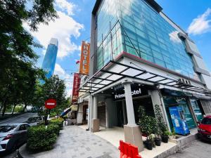 a building with a red bench in front of it at Prime Hotel at TRX Tower in Kuala Lumpur