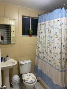 a bathroom with a toilet and a shower curtain at Casa de Campo in Santa Cruz