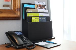 a phone sitting on a desk next to a book shelf at Four Points by Sheraton Balikpapan in Balikpapan