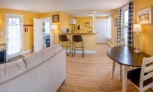 a living room with a couch and a table at Historic 2 Cats Inn in Bar Harbor