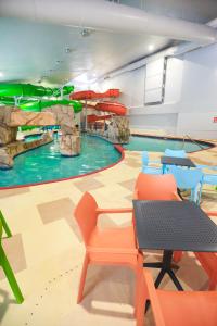 a swimming pool with a water slide in a room at Rapid River Lodge in Baxter