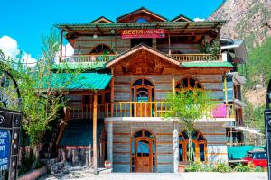 a wooden building with a sign on top of it at Diya Palace Kasol in Kasol