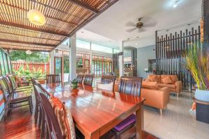 a dining room with a table and a couch at The One Cozy Vacation Residence SHA Hotel in Chalong 