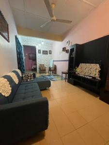 a living room with a couch and a fireplace at EQ Malay Modest Homestay Port Dickson in Port Dickson