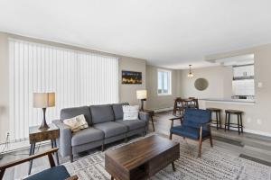 a living room with a couch and a table at Newly Renovated 2 Bedroom Downtown Saskatoon Condo in Saskatoon