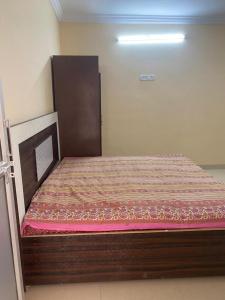 a large bed in a room with avertisement at Chabbra niwas kanpur in Kānpur