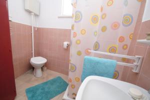 a bathroom with a toilet and a shower curtain at Art Apartment in Vela Luka