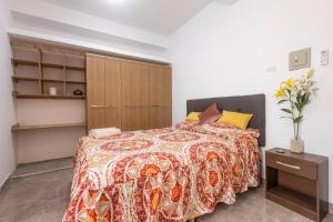 a bedroom with a bed and a wooden cabinet at LUNA's HOME - Luxury 201 in Tarapoto