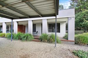 a house with awning and plants on a patio at Grevillea Gardens Unit 8 in Bright