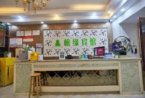 a counter in a restaurant with a sign on the wall at Songyuan Hotel 松缘酒店 in Shenzhen