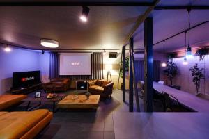 a living room with a couch and a table at The Landmark in Furano