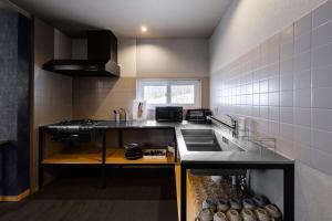 a kitchen with a sink and a counter top at The Landmark in Furano