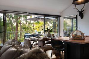 a living room with a couch and a table at Negroni Lane in Hepburn Springs