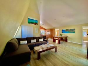 a living room with a couch and a coffee table at Surf Club House, Pet Friendly, Sunshine Coast, Holiday House, Marcoola in Marcoola