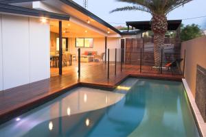 a swimming pool in a house with a deck at Marcoola House, Pet Friendly, Sunshine Coast in Marcoola