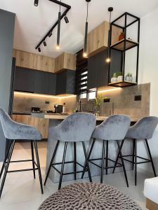 a kitchen with gray chairs and a kitchen island at Casa De Afrodite in Argostoli