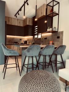 a kitchen with blue chairs and a kitchen island at Casa De Afrodite in Argostoli