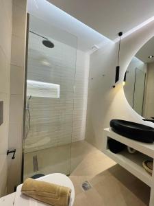 a bathroom with a toilet and a glass shower at Casa De Afrodite in Argostoli