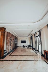 an empty room with two tables and windows at Ha Long Essence Classic Hotel in Ha Long