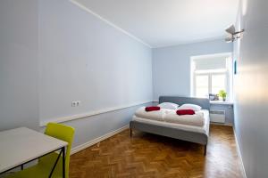 a bedroom with a bed and a table and a window at Tallinn Guest House in Tallinn