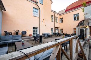 a patio with tables and chairs on a wooden deck at Tallinn Guest House in Tallinn