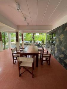a dining room with a wooden table and chairs at Villa Aisawan in Phuket