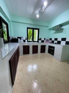 a large room with a large kitchen with counters at Villa Aisawan in Phuket