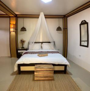 a bedroom with a large bed with a canopy at TLT Guest Houses 