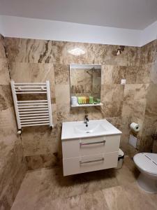 a bathroom with a sink and a toilet at Casa Eva in 2 Mai +46 photos