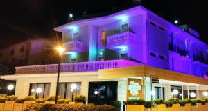 a building with purple lights on top of it at Hotel Nuovo Belvedere in Rimini