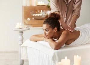 a woman getting a massage from a therapist at Riad Zouhour in Marrakesh