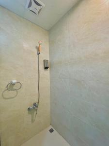 a bathroom with a shower with a shower head at Xinzhan 23 B&B in Taitung City